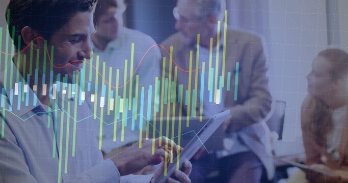 Tapping executive using tablet in boardroom as colleagues observing with stock overlay, copy space