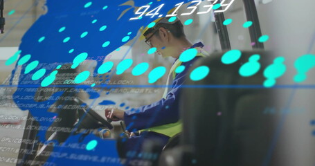 Worker in safety gear operating machinery with digital data overlay image