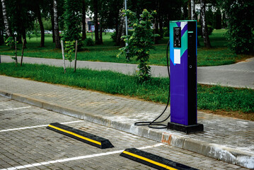 Power supply for charging of electric car on parking lot. Electric car charging station.