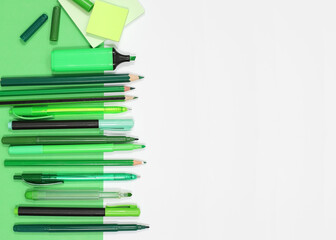 Green School Supplies on Green Background with White Copy Space, Top View