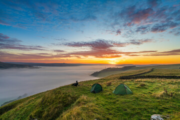 Winnats Pass peak at sunrise with cloud investion in the valley over Castleton. Peak District. England