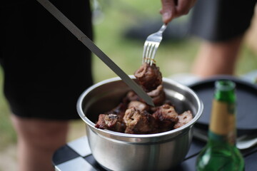 grilled pork shashlik, taking the shashlik off the skewer, close-up shot