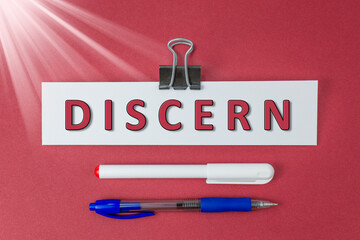 Discern text on paper on red background
