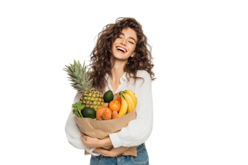 Happy woman holding a grocery bag full of fresh fruits.
