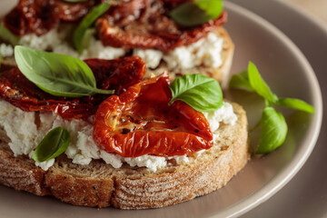 Ciabatta with sun dried tomatoes in olive oil, creamy cheese, and basil.