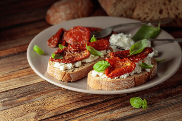 Ciabatta with sun dried tomatoes in olive oil, creamy cheese, and basil.