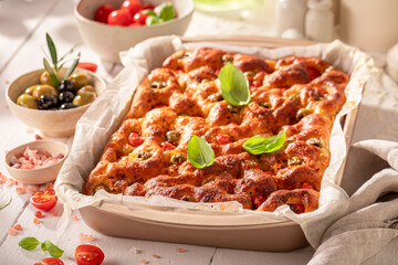 Homemade focaccia made of cherry tomatoes and basil.