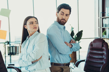 Confident coworkers working on a collaborative project in a modern office with team spirit and...