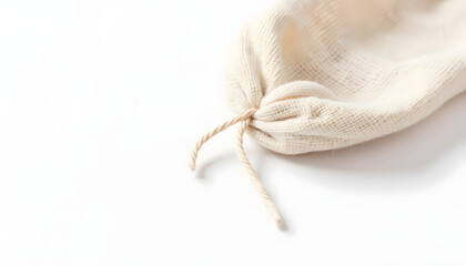 Natural fabric drawstring bag made of light beige material, showcasing texture and detail, ideal for eco-friendly packaging and storage solutions in various settings