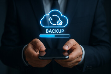 Person holding phone with backup cloud icon and progress bar on screen in dark suit jacket