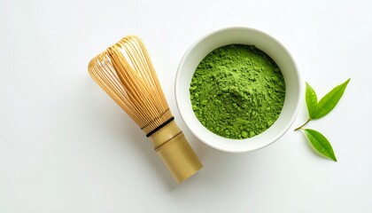 White ceramic bowl with vibrant green matcha powder, bamboo whisk.