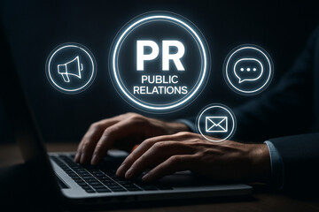 Human hands typing on a laptop with public relations icons hovering over the keyboard in the dark