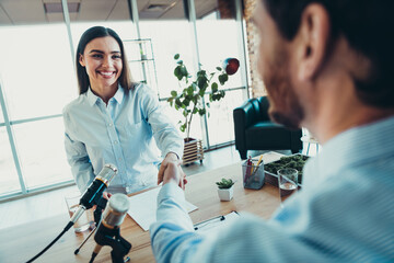 Professional handshake during an office interview showcasing teamwork, collaboration, coworking