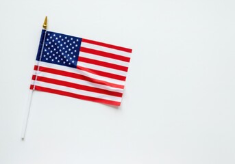 Fototapeta premium An american flag waving isolated on white background in studio shot