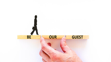 Be our guest symbol. Concept words Be our guest on beautiful wooden block. Businesswoman's icon....