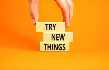 Try new things symbol. Concept words Try new things on beautiful wooden block. Businessman's hand....