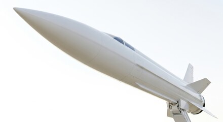 A sleek, white hypersonic missile or advanced aircraft with a sharp nose cone, poised for flight against a bright, clear sky, representing cutting-edge aerospace technology.