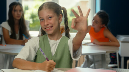 Happy girl school student pupil smiling kid child friendly schoolgirl daughter teen in classroom...