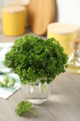 Fresh parsley in jar on table indoors