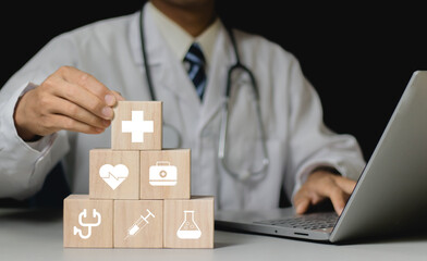 Businessman hand arranging wood block stacking with the healthcare medical icon. Health insurance  health concept