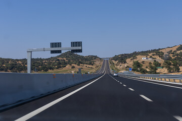 Fototapeta premium empty highway in Italy with a blue sky and clouds