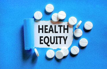 Health equity symbol. Concept words Health equity on beautiful white paper. White pills tablets....