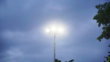 Streetlight glowing through cloudy evening
