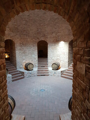 Wine cellar with oak barrels in Valtice, Czechia, showing traditional winemaking process