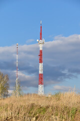 The communication tower is painted in red and white. A communications tower in rural areas.