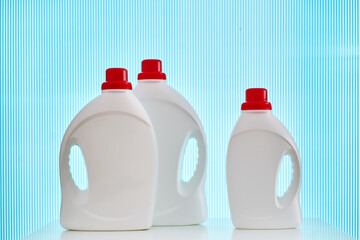 Three bottles of laundry gel on a blue background.