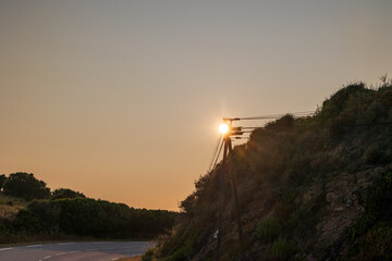 Sunset with power lines along coastal road, Corsica, Sagone, 11 June 2025