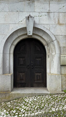 Stone archway with ancient wooden doors whispers secrets of bygone eras, perfect for Halloween...