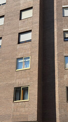 Sunlight dances on the textured brick facade, urban serenity echoing Dia de la Construccion and World Architecture Day