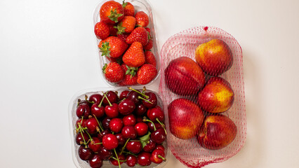 Juicy nectarines, cherries, and strawberries evoke midsummer solstice feasts, capturing vibrant...