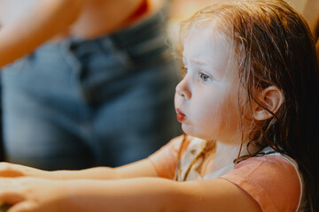 An expressive 3-year-old girl watches cartoons on a tablet, capturing genuine childhood reactions...