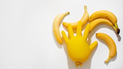 Playful juxtaposition of bananas and inflatable glove sparks whimsy, fruit sculpture art, National...