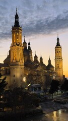 Obraz premium Majestic cathedral glistening at dusk, whispers of Epiphany and Fiesta de San Lorenzo in architectural splendor, perfect twilight enchantment