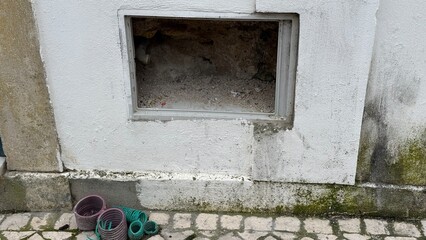 Weathered brick portal whispers forgotten tales, accompanied by abandoned flower pots, evoking...