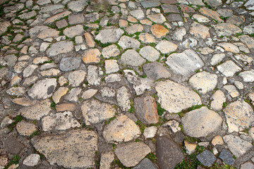 Close up of a weathered and worn cobblestone floor