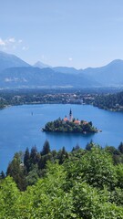 Scenic view of Lake Bled in Slovenia with the famous island church and surrounding Alps. A popular travel destination known for its crystal-clear water and fairytale atmosphere.