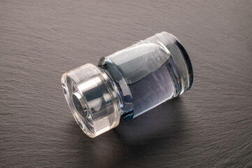 One bottle of perfume on slate stone, macro.