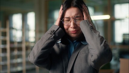 Stress work problem annoyed Asian Chinese Korean business woman holding head pain headache...