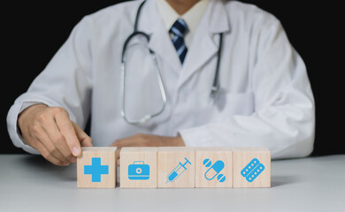 Health insurance concept, Doctor stacking wooden cubes with medical icons for healthcare and medical. health and access to welfare health.