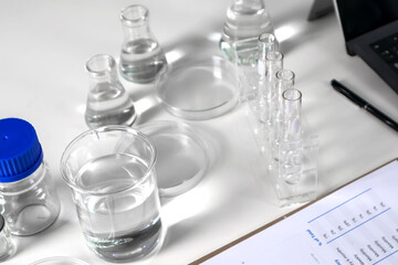 Clear bottles and dishes are used in scientific and medical experiments.