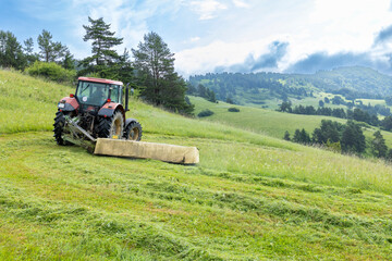 Tractor Mowing Lush Hills in Presovsky Kraj, Slovakia