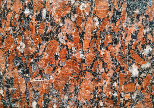Natural stone dark red granite texture background. Bright hard red granite texture. Red granite texture stone background. Red granite texture untreated surface. Facing material horizontal background.