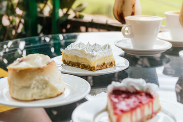 A table with a variety of desserts and a cup of coffee