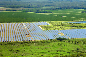 Aerial view of sustainable electrical power plant between agricultural farmlands with photovoltaic...