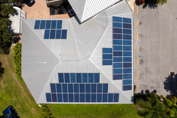 Residential house in USA with rooftop covered with solar photovoltaic panels for producing of clean...