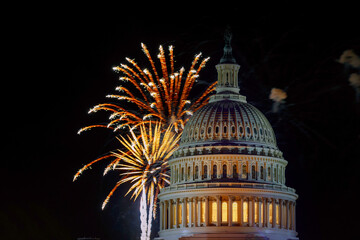 Colorful fireworks burst at night sky above US Capitol dome, creating festive atmosphere for event...